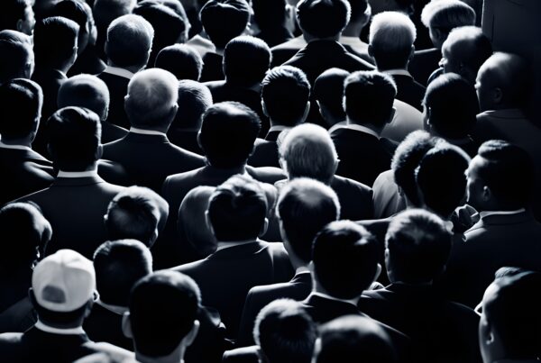 A large crowd of business professionals facing forward in a monochrome setting.
