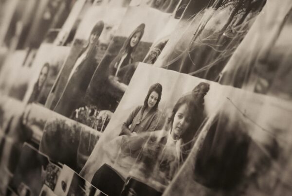 An array of vintage black and white photographs displayed on a wall, creating a nostalgic collage of history and memories.