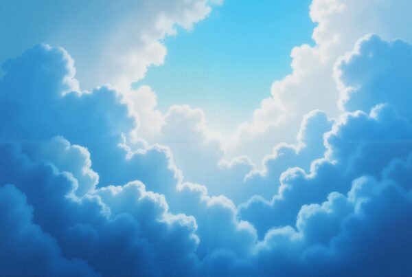 A serene sky filled with soft, fluffy clouds and vibrant blue patches creates a tranquil and uplifting scene.