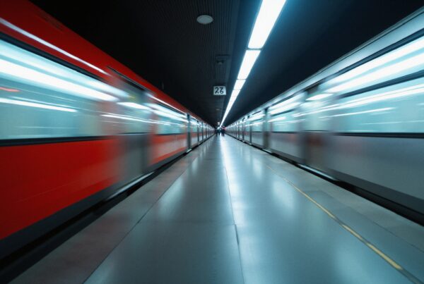 High-speed trains at subway station displaying motion blur.