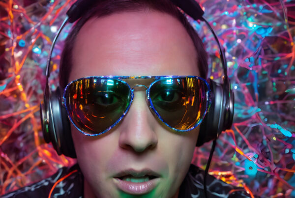 Party DJ with Reflective Sunglasses in Vibrant Club Setting