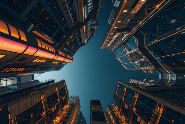A futuristic cityscape with illuminated skyscrapers against a deep blue night sky.