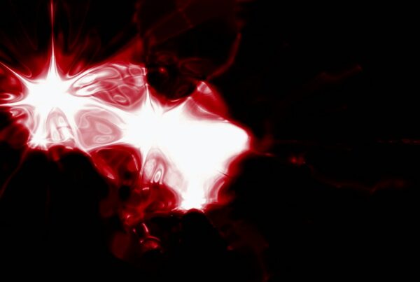Abstract digital video loop featuring vibrant red and white star-like shapes emitting light against a dark background, creating a striking and dynamic visual experience.