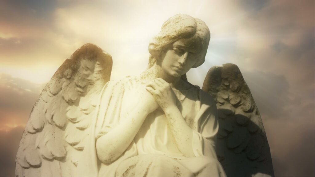 Serene angel statue against radiant time-lapse sky.