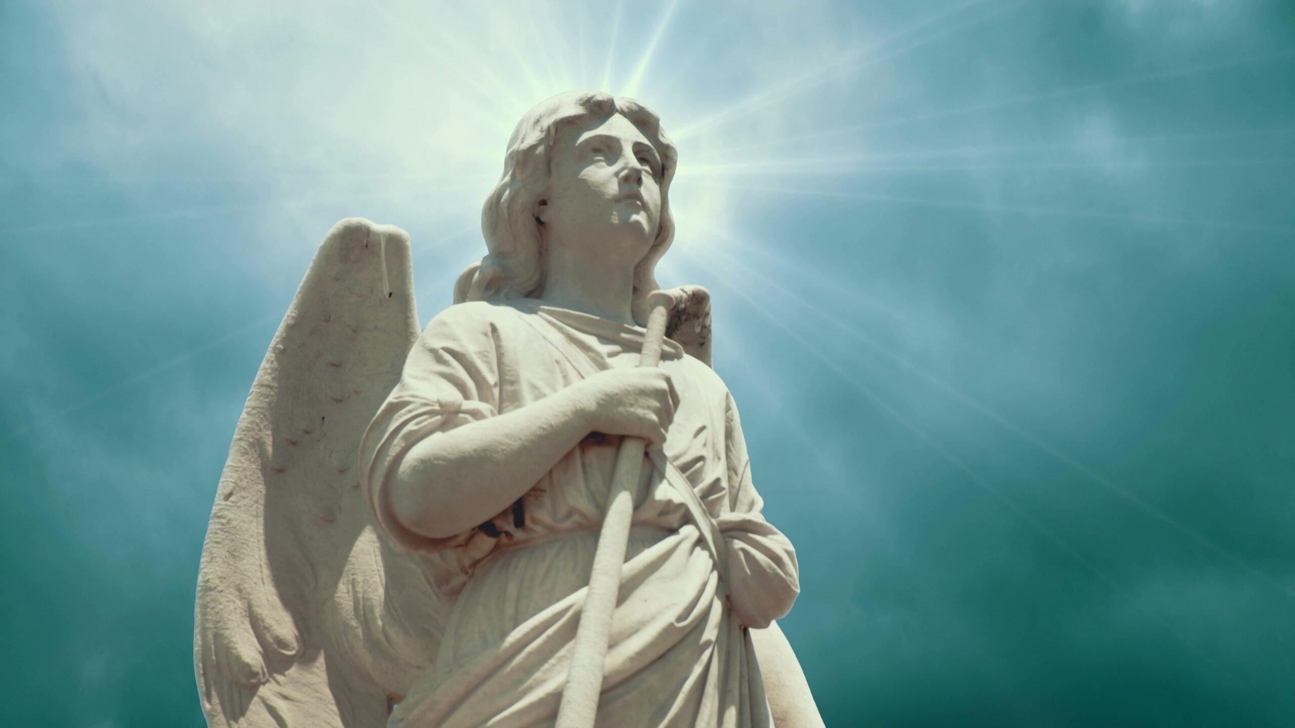 Angel Statue Under Radiant Sky 4K Loop