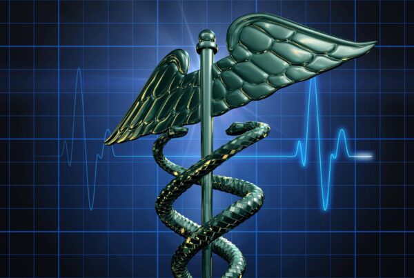 4K video showcases a shiny caduceus symbol with two snakes encircling a winged staff, set against a blue EKG background.