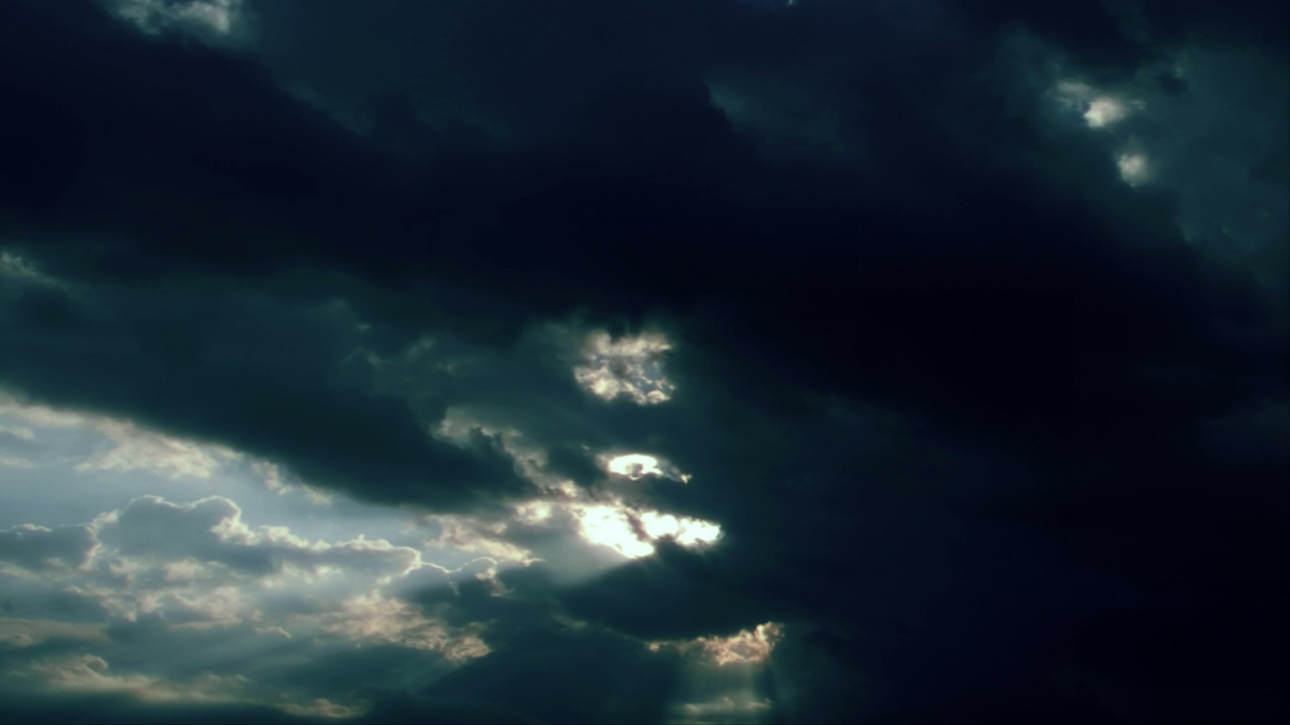 Stormy Time-Lapse Clouds with Sunlight Peeking