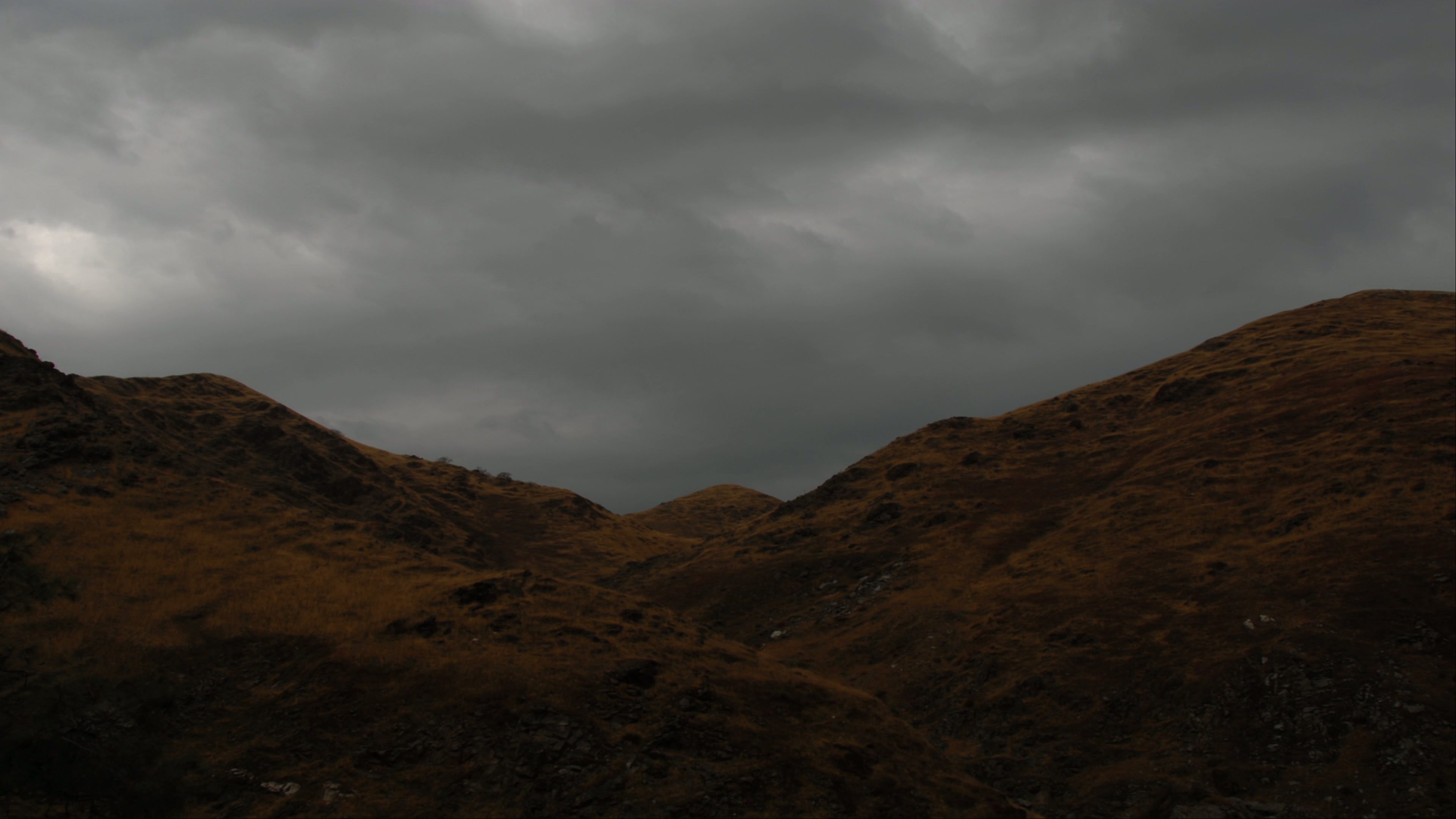 Overcast Time-Lapse Sky Above Rolling Hills 4K Video