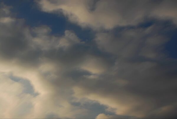 4K video of a dark evening sky filled with thick, moody time-lapse clouds.