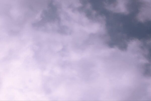 Serene sky filled with soft time-lapse clouds.