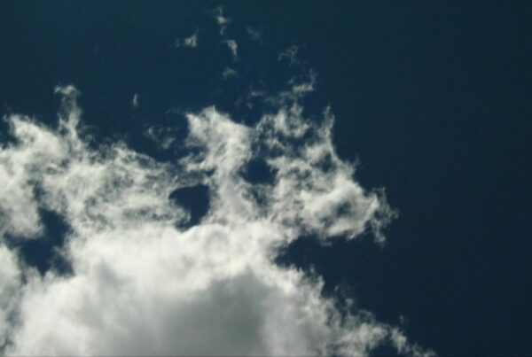 HD video of white fluffy time-lapse clouds in a deep blue sky.