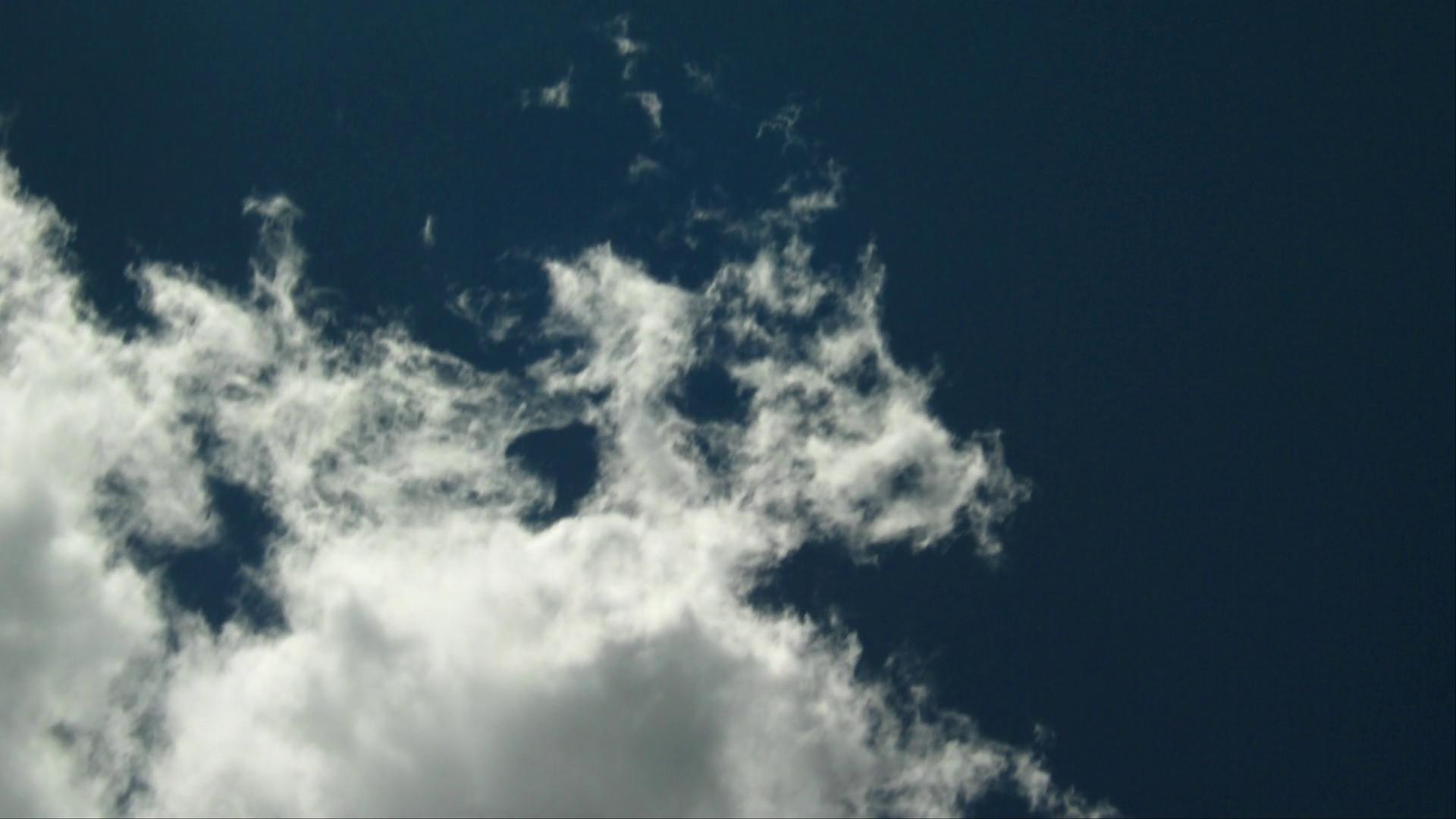 Fluffy Time-Lapse Clouds Against Blue Sky