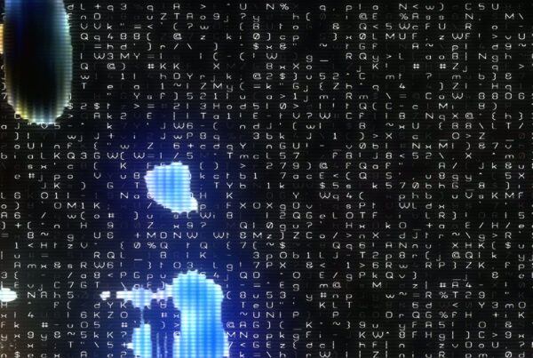 An abstract digital animation loop featuring a chaotic array of white alphanumeric characters and symbols against a dark background, with glowing blue and orange highlights, representing the theme of technology and data flow.