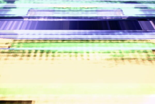 Abstract video loop with dynamic horizontal bands in blue, green, yellow, and purple hues, creating a vibrant glitch art effect with a sense of energy and texture.