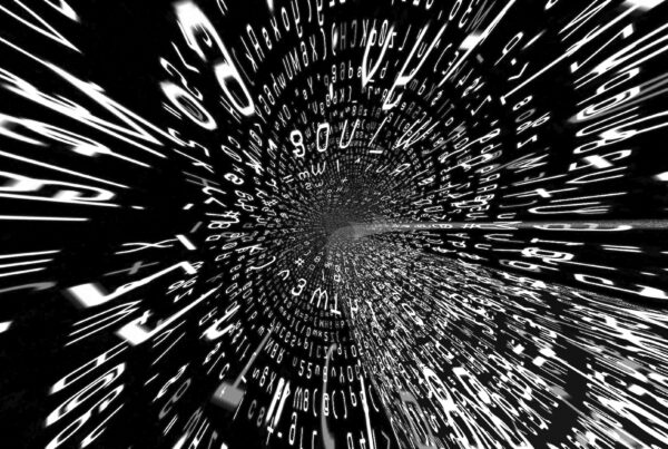 Abstract 4K video loop of a swirling tunnel of alphanumeric characters suggesting data flow.