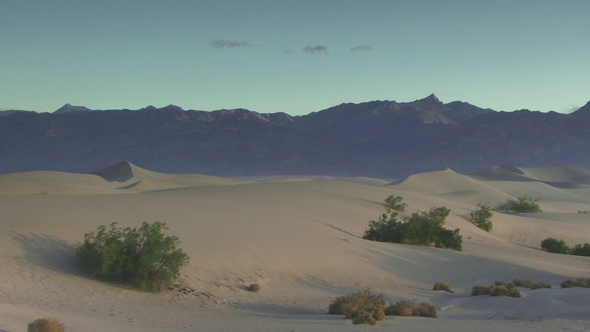 Serene Desert Dunes and Mountains