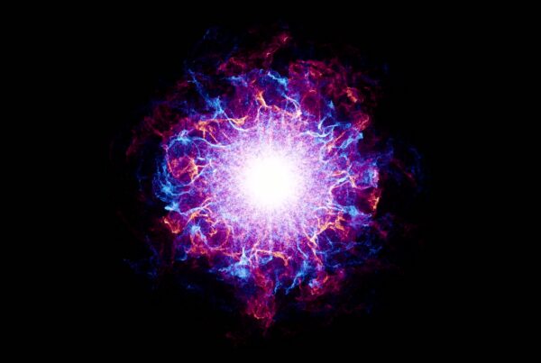 An abstract video loop explosion of colors set against a black background. At the center is an intense, bright white light, radiating energy outward.