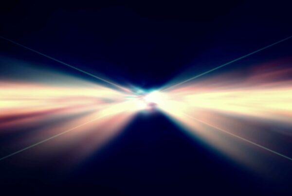 Abstract video loop depicting a prismatic burst of light radiating from the center against a dark background, showcasing dynamic beams and spectrum colors for a futuristic effect.