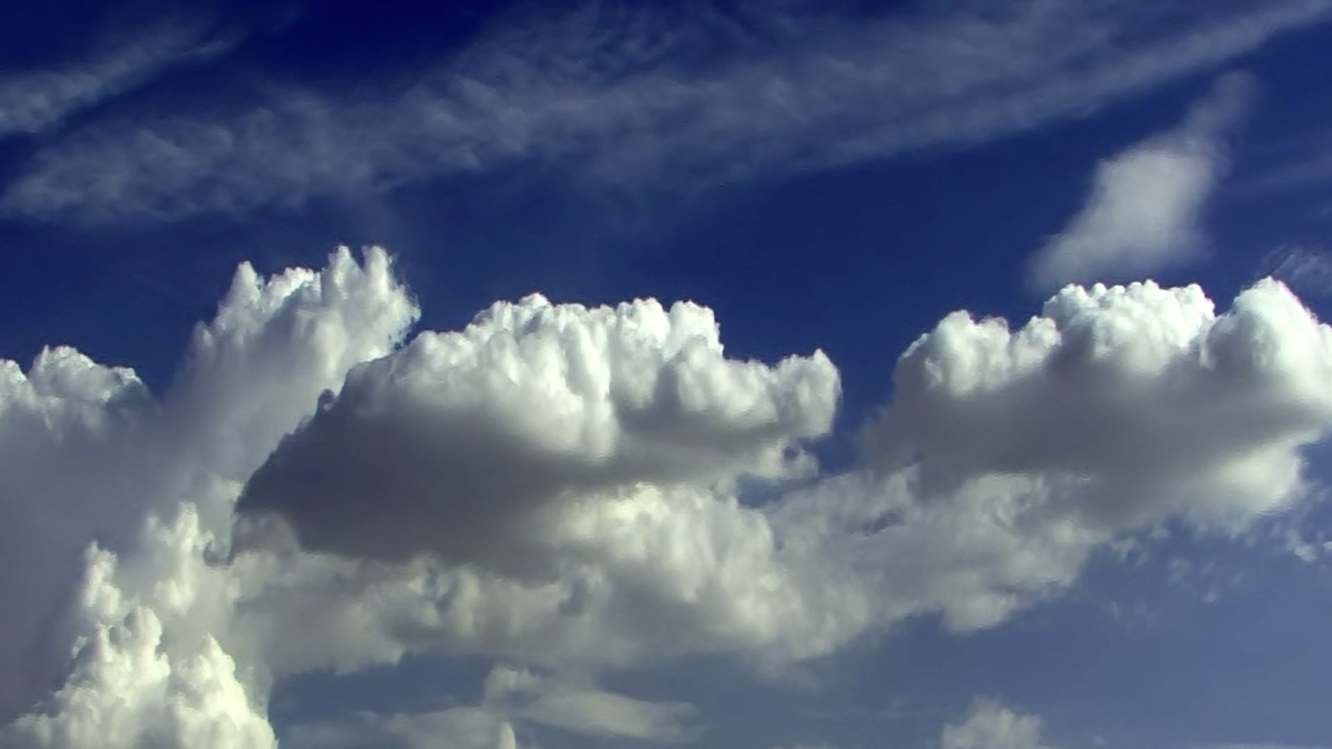 Turbulent Time-Lapse Clouds Against Blue Sky