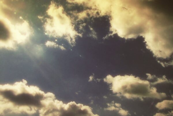 The video is a captivating view of time-lapse clouds, some white and others with a hint of gray, float across the screen.