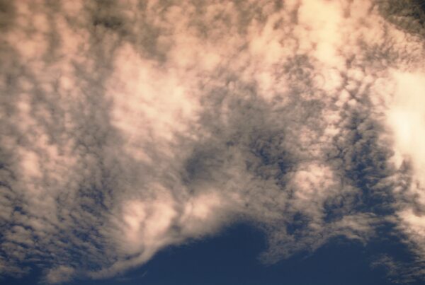 Clouds drift over calming twilight sky