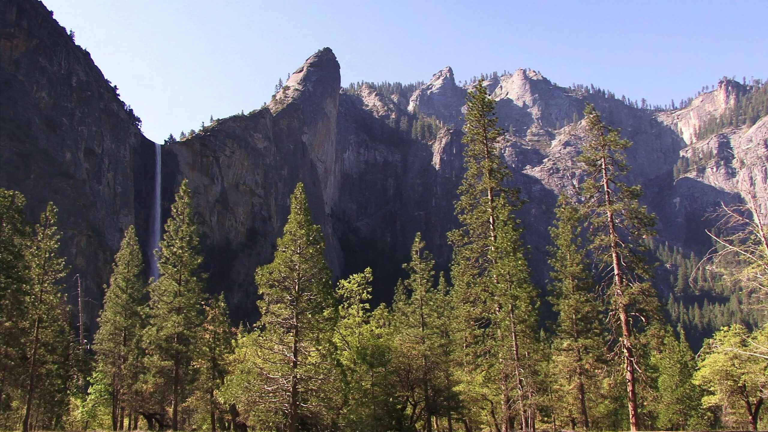 Majestic Waterfall Amidst Rocky Peaks 4K Video
