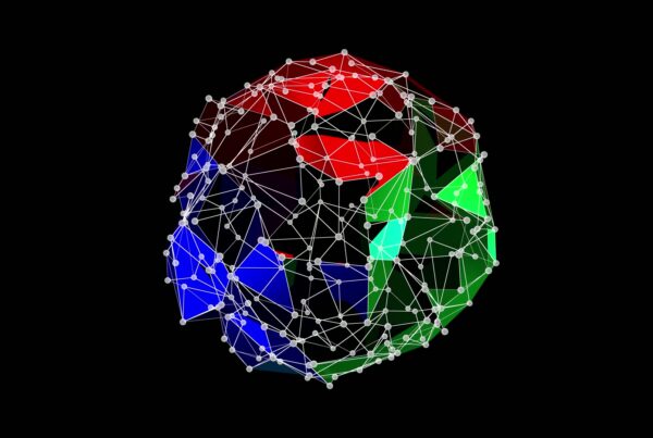 Abstract 3D geometric animating structure with vibrant red, green, and blue triangular facets connected by a network of white lines and nodes against a black background, emphasizing connectivity and modern design.