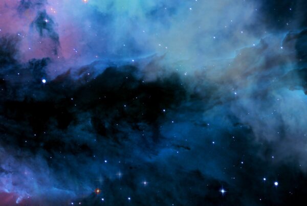 A stunning interstellar cloud bathed in vivid colors and twinkling stars, showcasing the majestic beauty of deep-space phenomena.