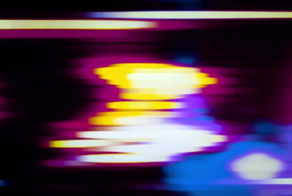 Abstract video loop showcasing a vibrant blend of pulsing blue, purple, and yellow colors, illustrating dynamic motion and energy.