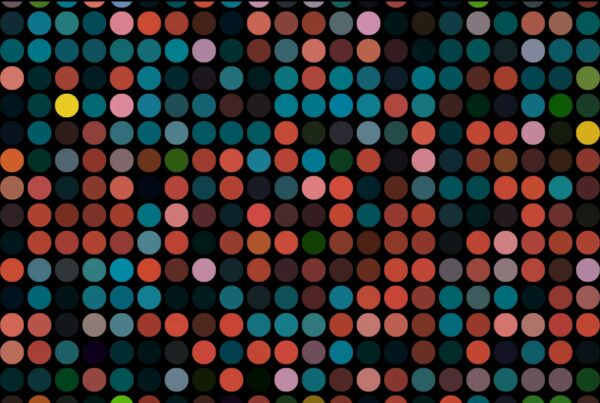 Abstract looping video featuring a grid of multicolored dots against a black background, showcasing vibrant teal, red, orange, pink, and yellow shades in a modern geometric pattern.