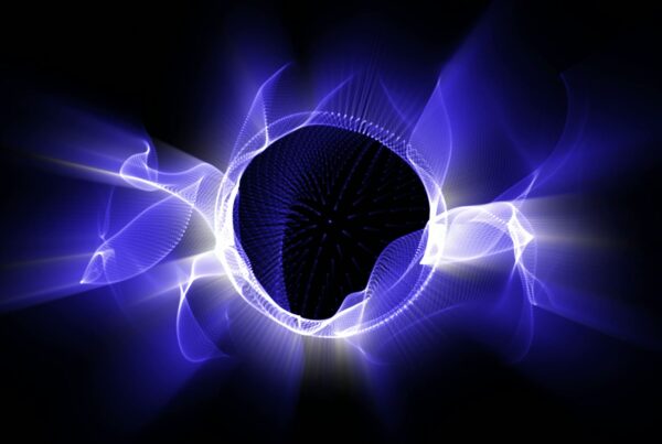 Abstract video loop of swirling blue and white light patterns radiating from a central black sphere against a dark background.