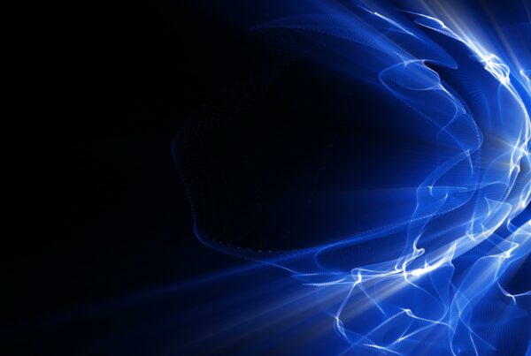 Abstract looping video animation of blue wave-like shapes on a dark background, glowing with light.
