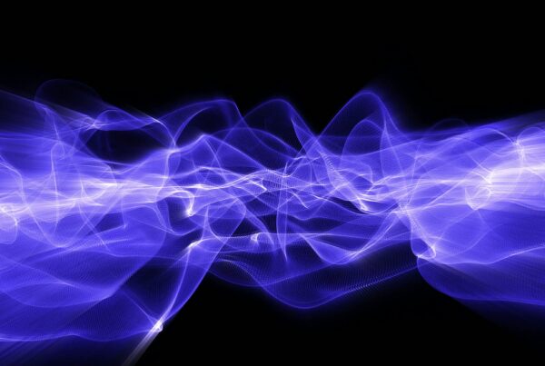 Abstract 4K looping video of blue light waves cascading on a black background.