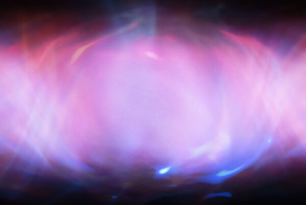 An abstract 4K video loop of glowing pink and purple light with cosmic and ethereal patterns.