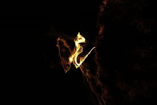 Abstract looping video animation featuring glowing orange and yellow light shapes against a black background, resembling flames or flowing ribbons, creating a dynamic and ethereal visual impression.