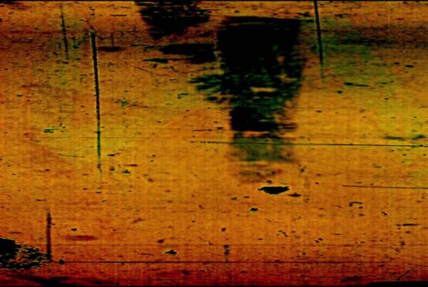 HD video of vintage 16mm film leader with scratches, dust, hand-drawn markings, and cyan light streaks on a green background.