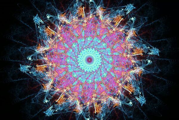 A vibrant and intricate fractal looping video with turquoise, pink, and blue hues, resembling an abstract energy burst against a dark background.