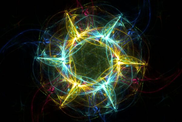 Abstract fractal art featuring a radiant star-like looping video with luminous blue and yellow swirls on a black background, accented by web-like patterns in red and green, creating a vibrant and dynamic visual effect.