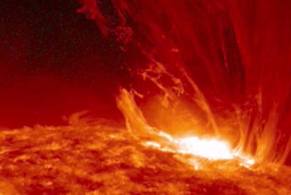 4K video of an intense solar flare erupting from the Sun's surface, showcasing vivid colors and plasma strands.
