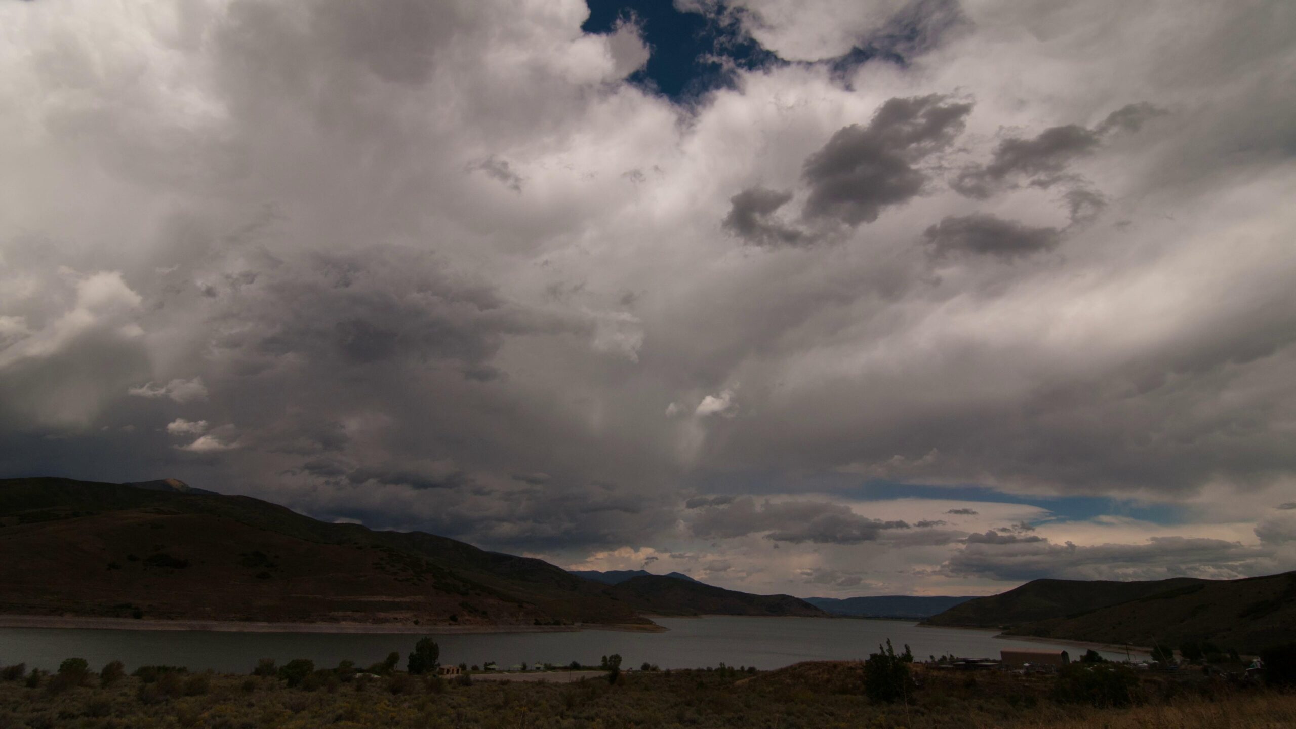 Time-Lapse Stormy Landscape Overlooking Serene Waters