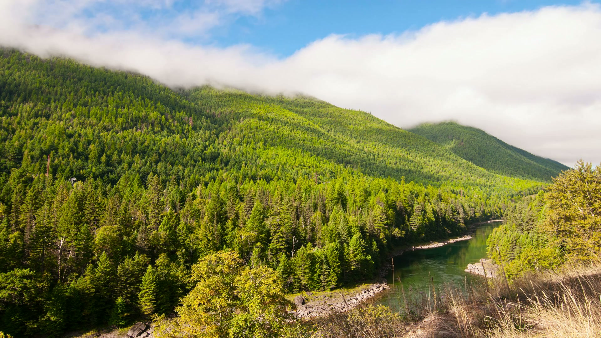 Lush Hills and Serene River in Time-Lapse