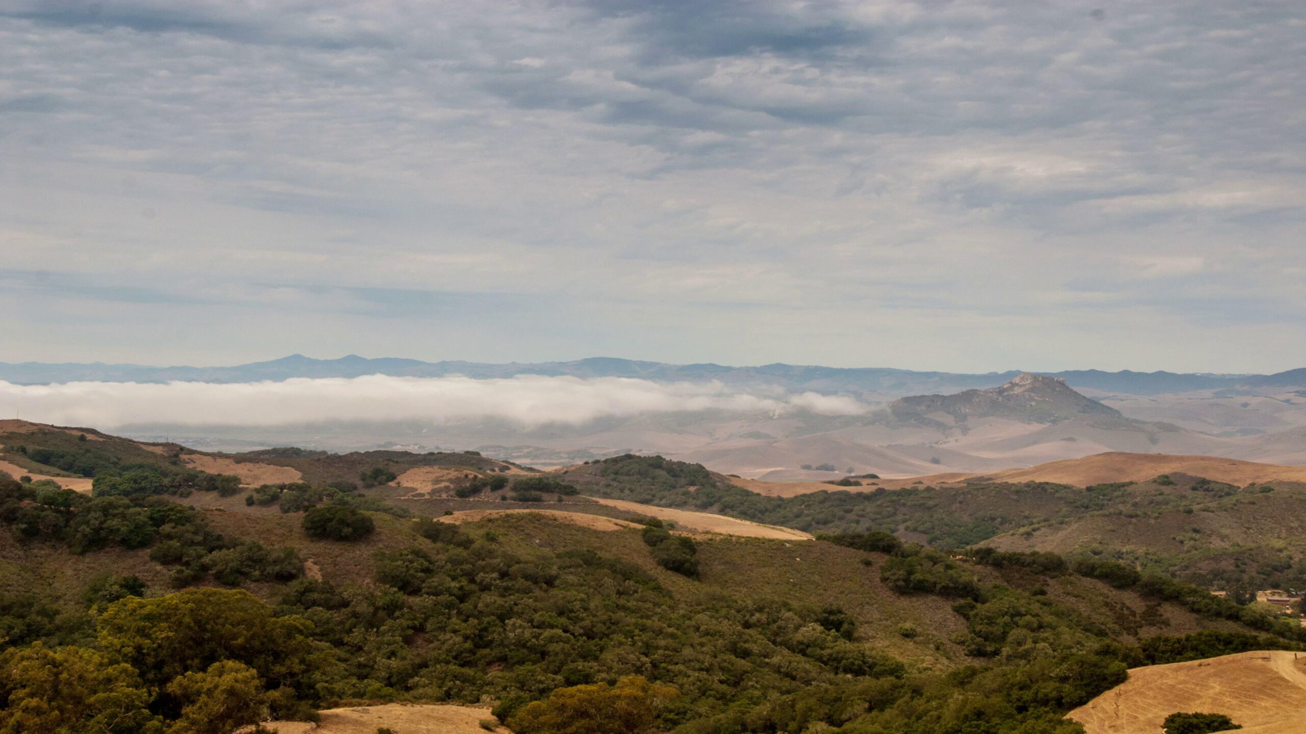 Time-Lapse Clouds Drift Over Rolling Hills