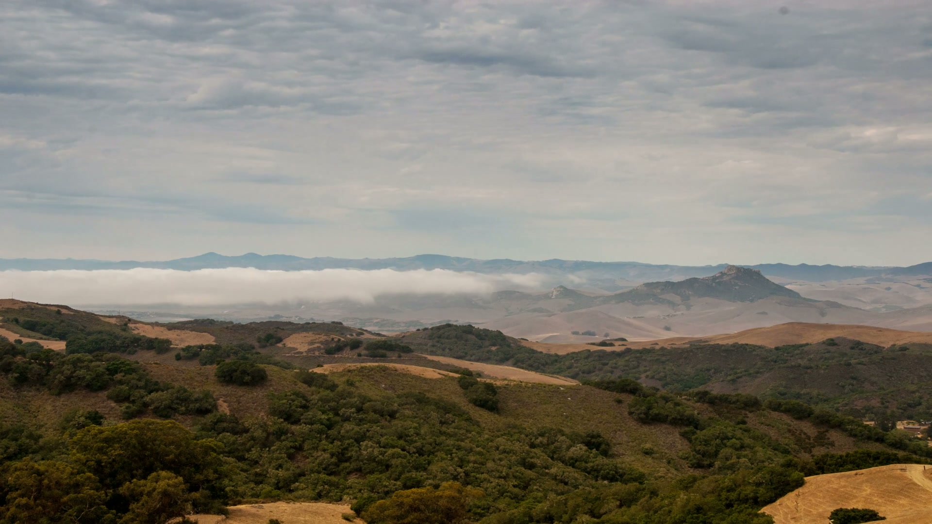 Hills and Time-Lapse Clouds in Harmony