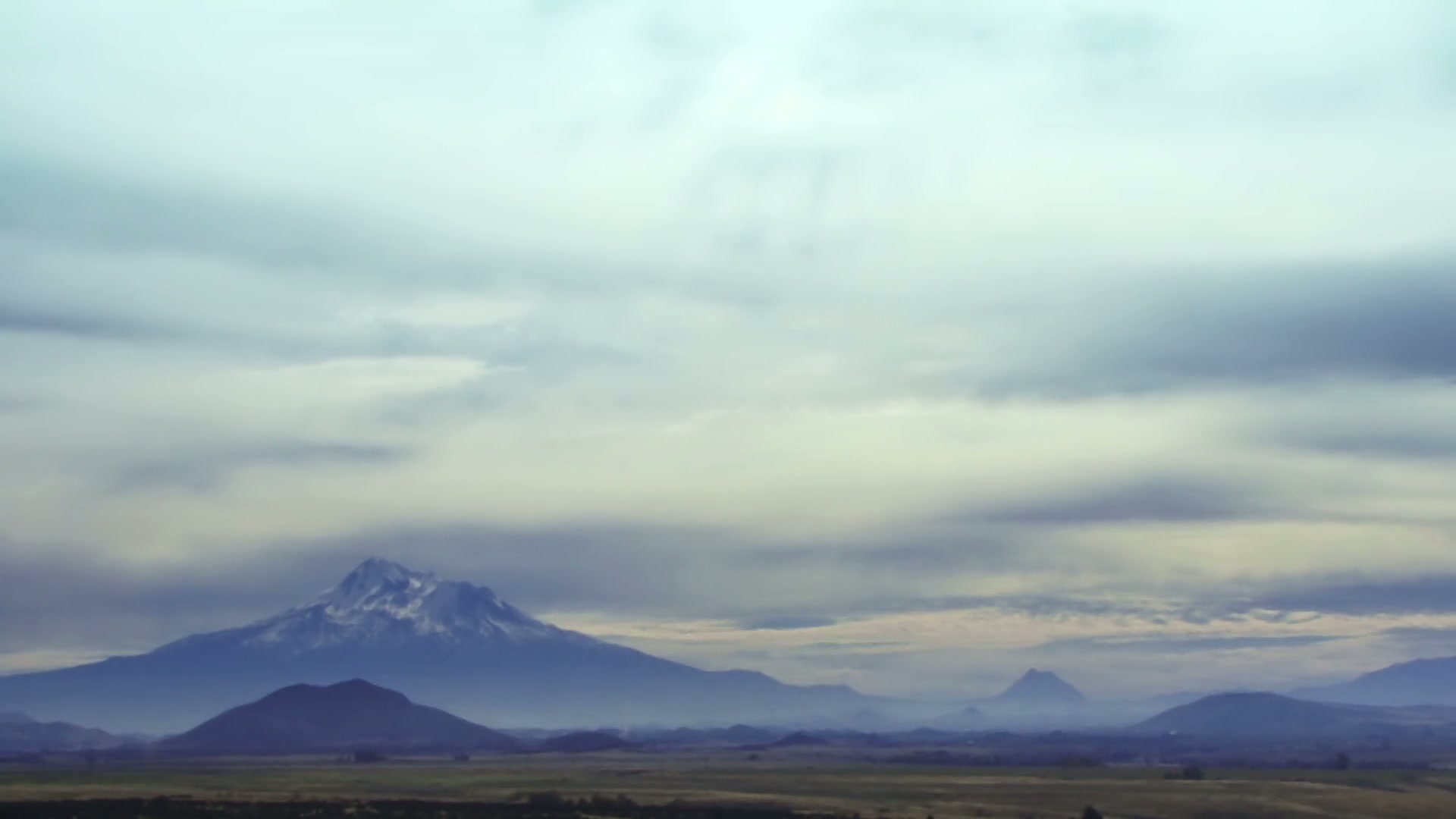 Majestic Mountain Under Time-Lapse Cloudy Skies