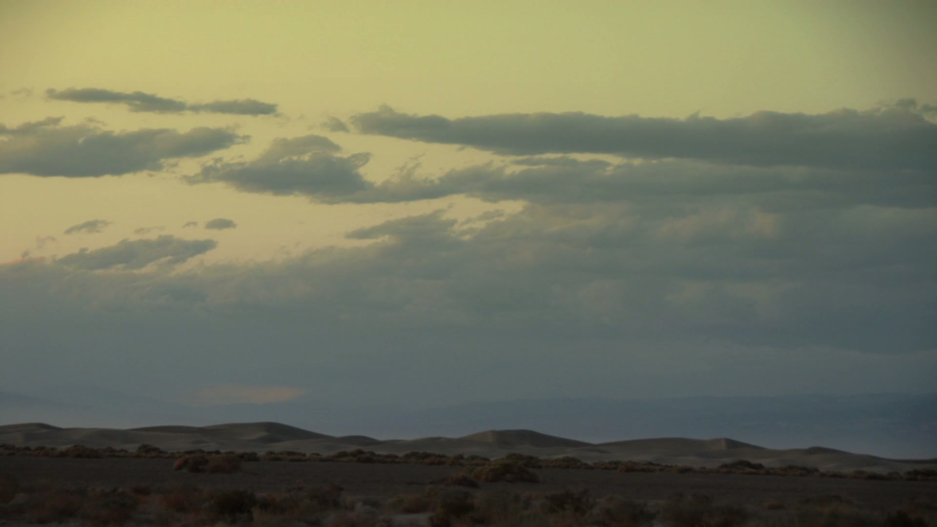 Serene Desert Under Time-Lapse Clouded Sky