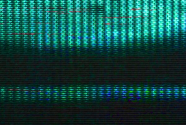 Video loop close-up of turquoise and green pixelated retro screen with horizontal bands and signal distortion effects.