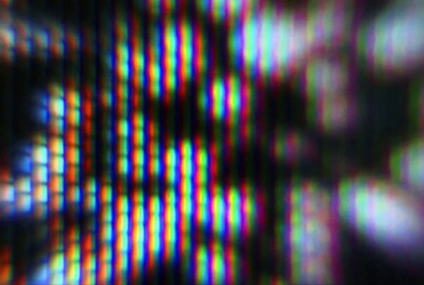 Close-up video loop of a colorful, abstract digital screen pattern with strobing RGB subpixels creating a vivid and vibrant kaleidoscopic effect.