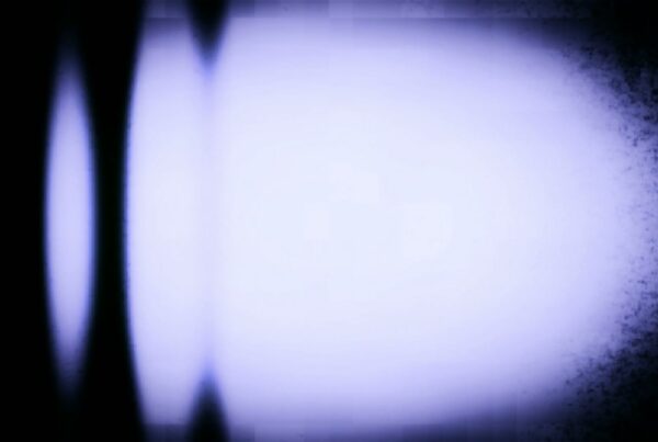 Abstract video loop of rolling TV static noise with glowing blue and white gradient and dark vignette edges.