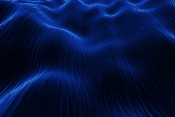 An abstract video loop featuring deep blue, wave-like patterns creating a serene and calming video reminiscent of ocean waves.