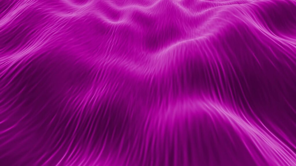 Abstract looping video depicting flowing purple waves with a silky texture, creating a sense of movement and tranquility.